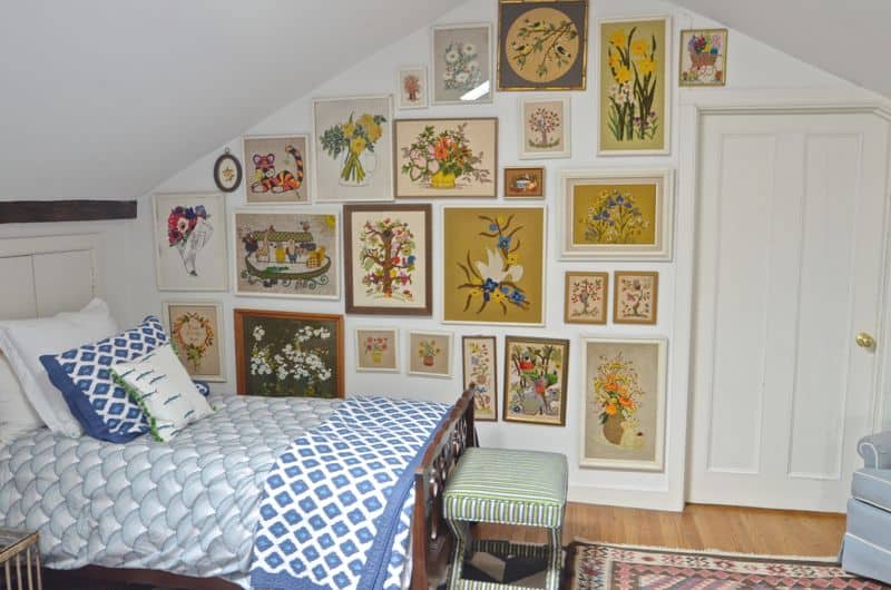 Guest bedroom with mixed patterns and textures. Gallery wall of embroidered art.