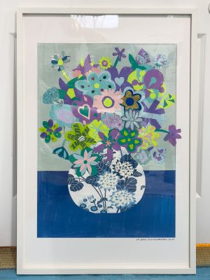 Framed artwork of a colorful bouquet with hearts and abstract flowers in shades of purple, green, and blue, set against a light and dark blue background. The vase is white with dark blue flower designs.