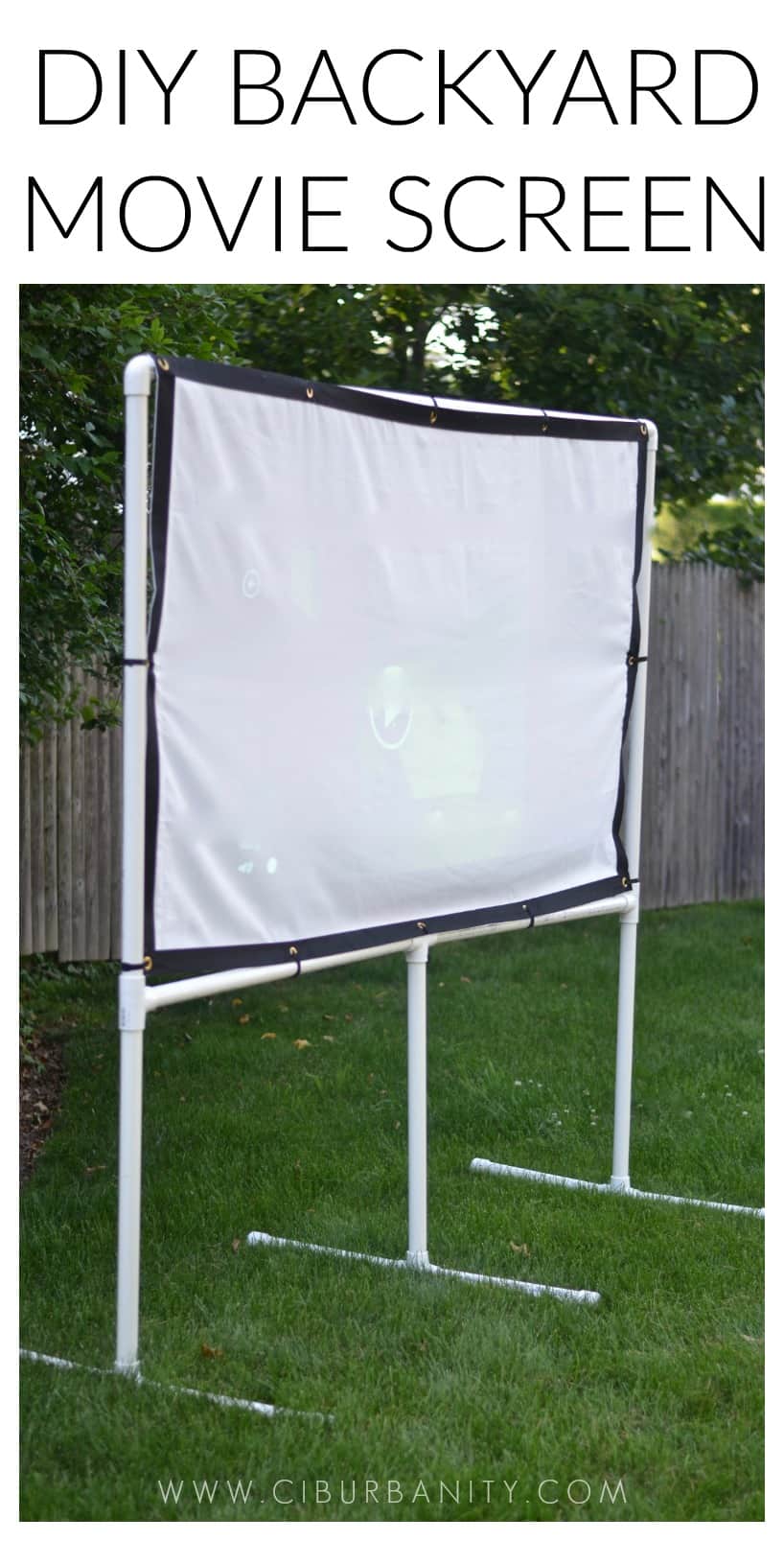 DIY backyard movie screen using PVC pipes and a clearance sheet.