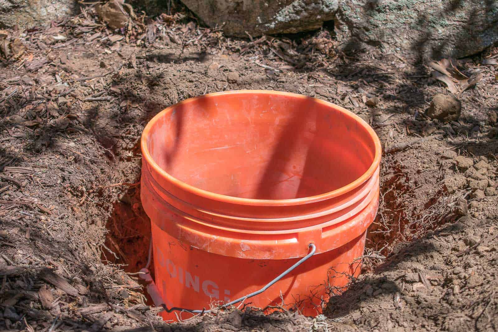 place the bucket in the hole