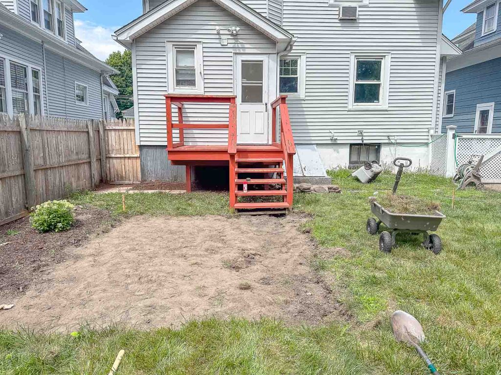 clearing the grass from the patio at the flip house