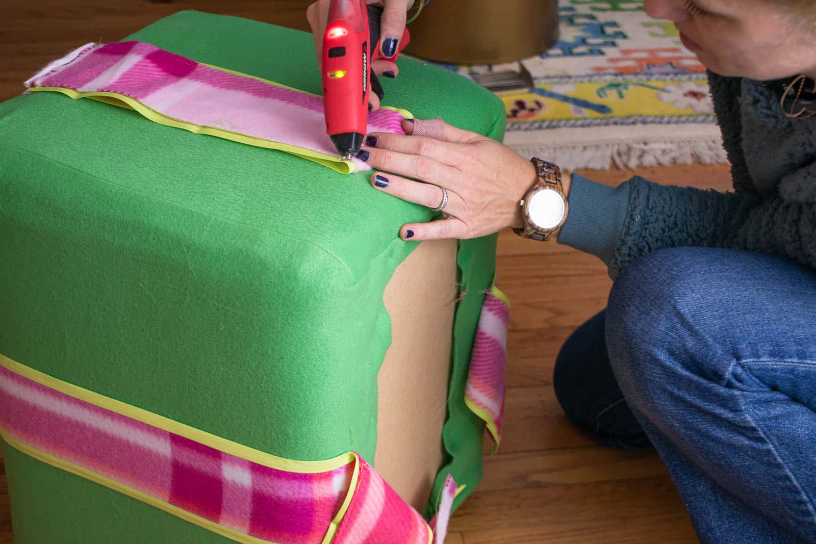 glue the fleece ribbons onto the ottoman