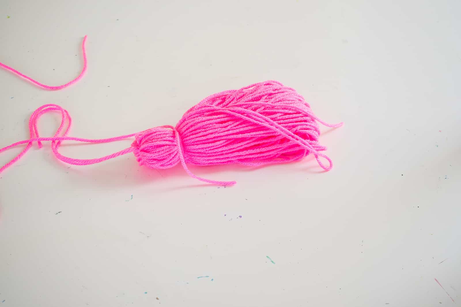 wrap the yarn around the top of the tassel