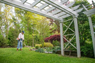 using a STIHL trimmer to clean up around our backyard
