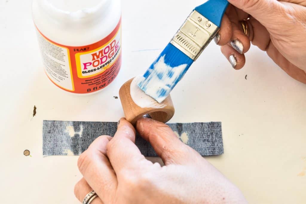use mod podge to seal fabric onto napkin ring