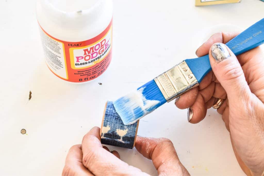 use mod podge to seal fabric onto napkin ring