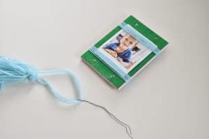 thread yarn through holes with floral wire