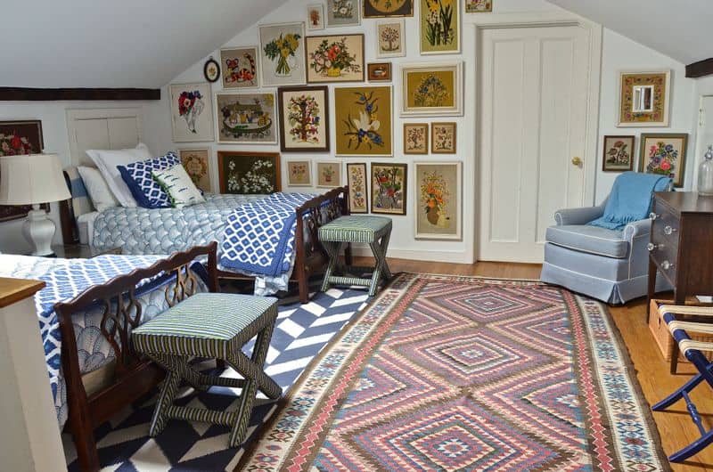 Guest bedroom with mixed patterns and textures. Gallery wall of embroidered art.