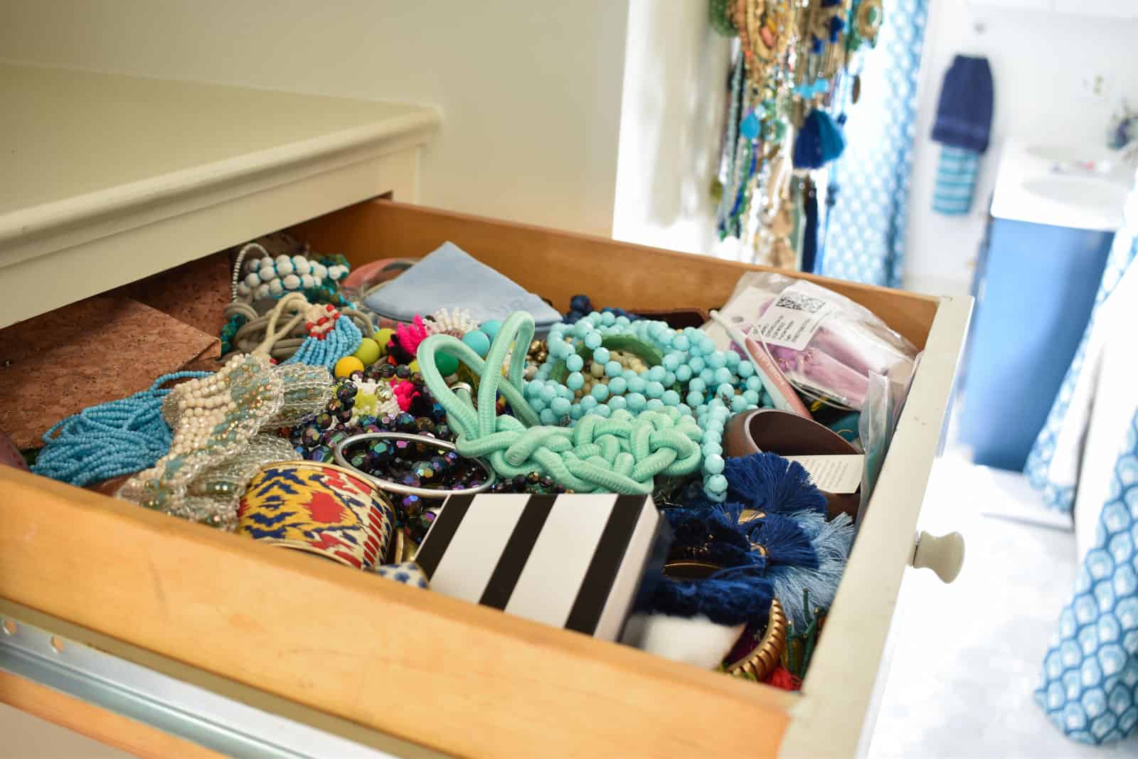 top drawer overflowing with jewelry