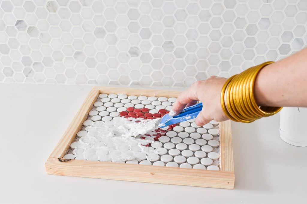 grout penny tiles on trivet