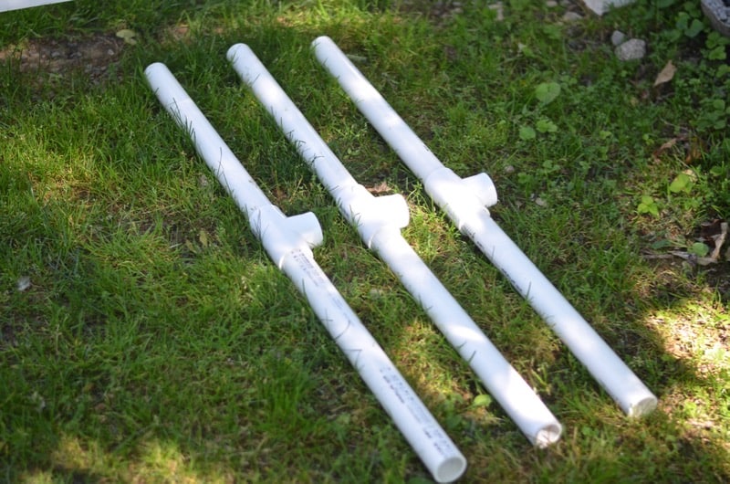 DIY backyard movie screen using PVC pipes and a clearance sheet.