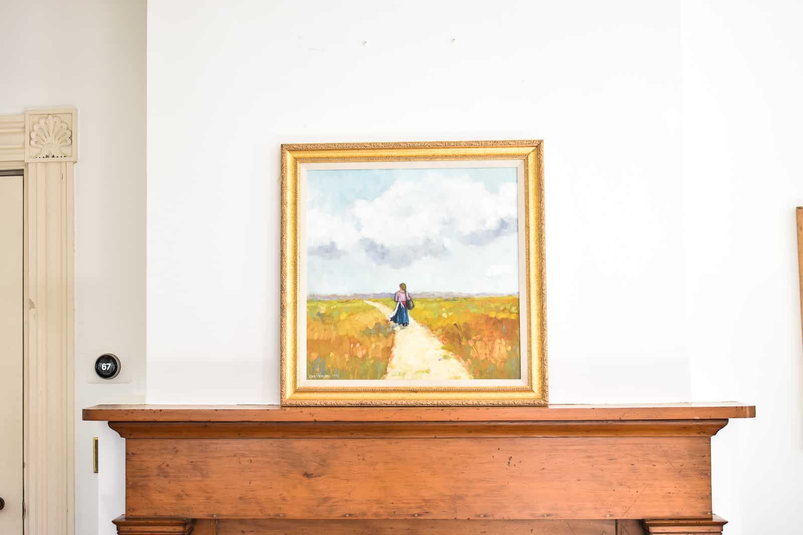 leaning artwork on the mantel